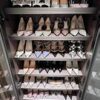 Closet shelf filled with women's high-heeled shoes
