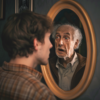 Young man sees older self in mirror