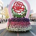 A float in the parade is decorated with flowers.