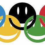 A group of smiling faces sitting in the middle of olympic rings.