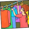 A woman is looking at clothes in the closet.